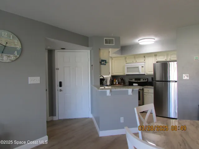 a kitchen with stainless steel appliances granite countertop a refrigerator and a stove