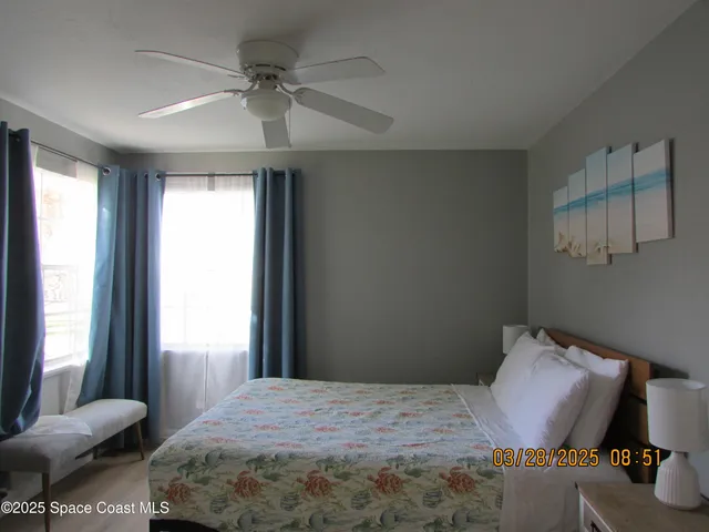 a bed room with a bed and a chair