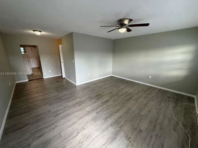 a view of an empty room and wooden floor