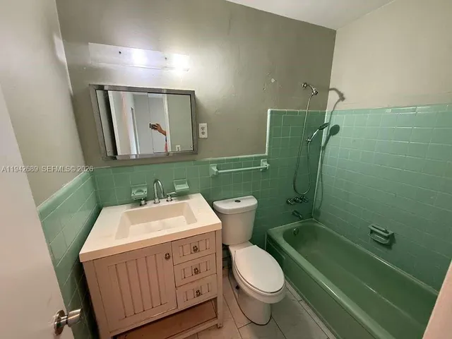 a bathroom with a sink toilet a mirror and shower
