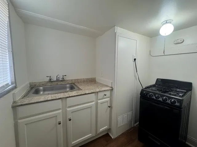 a utility room with sink dryer and washer