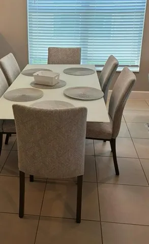 a blue and white table sitting in a bedroom next to a window