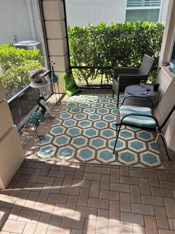 a view of a chairs and table in the backyard