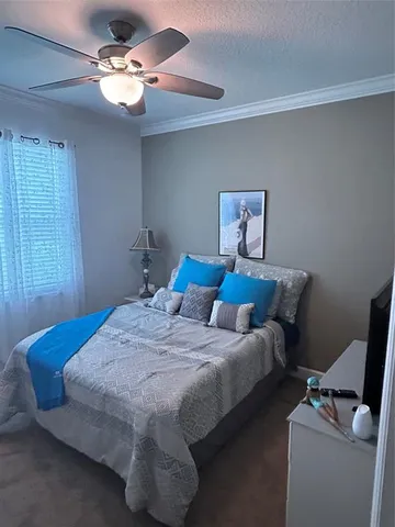 a bedroom with bed and a chandelier