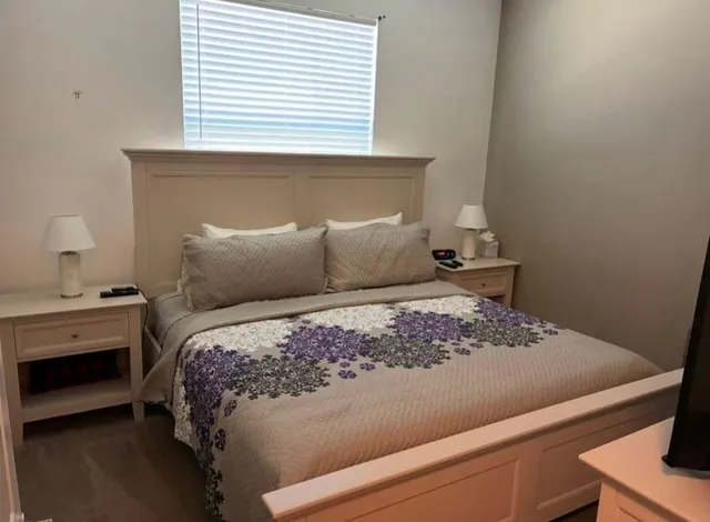 a bedroom with a bed and a window