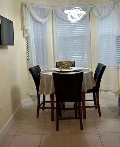 a dining room with furniture and window