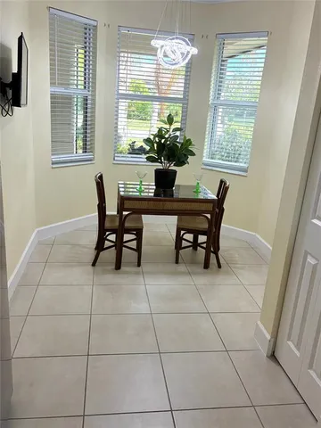 a dining room with furniture and window