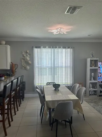 a view of a dining room with furniture and window