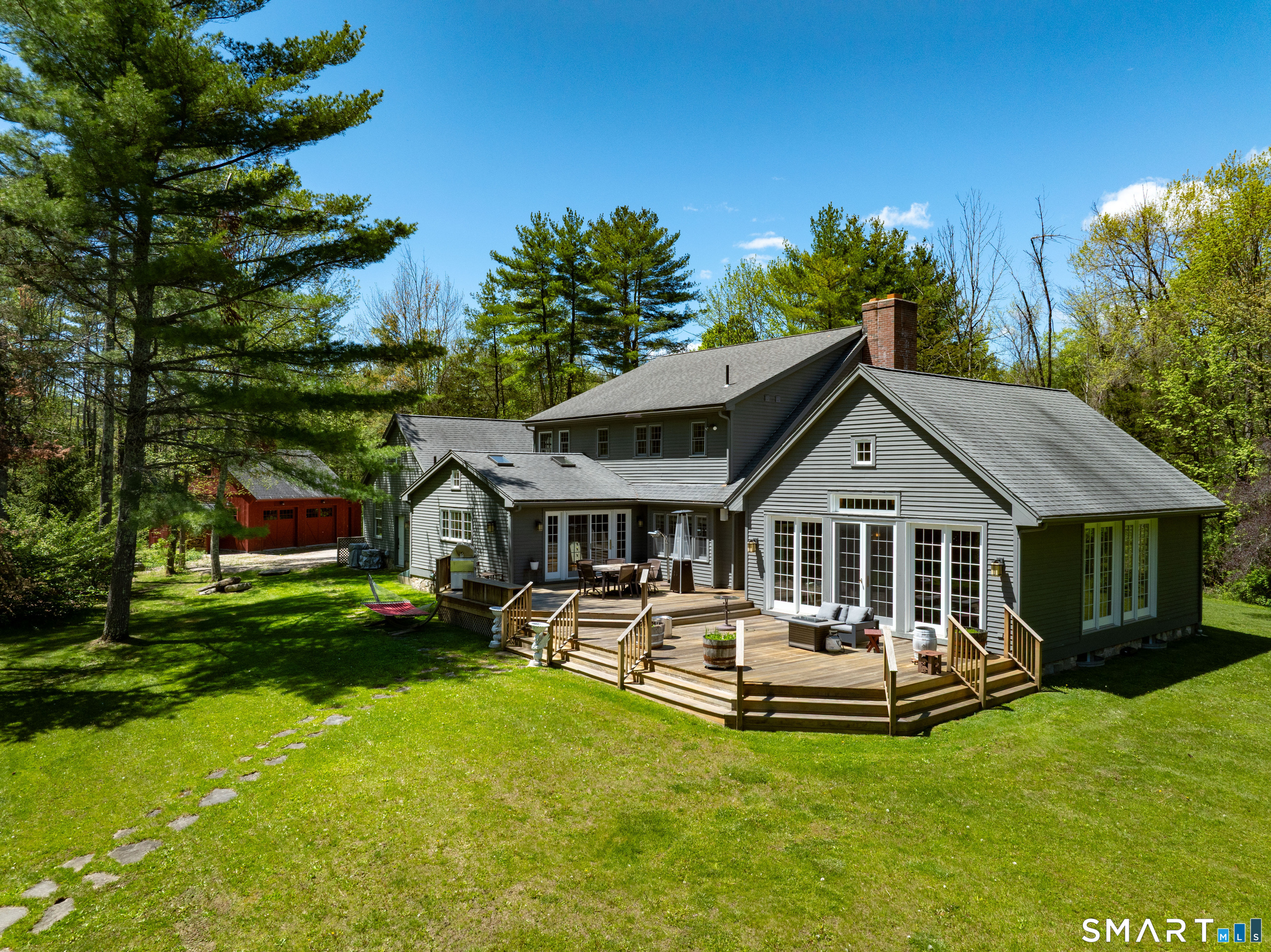 7 Cooper Hill Road Salisbury, CT 06068 - Photo 20 of 36 a front view of a house with a garden and trees