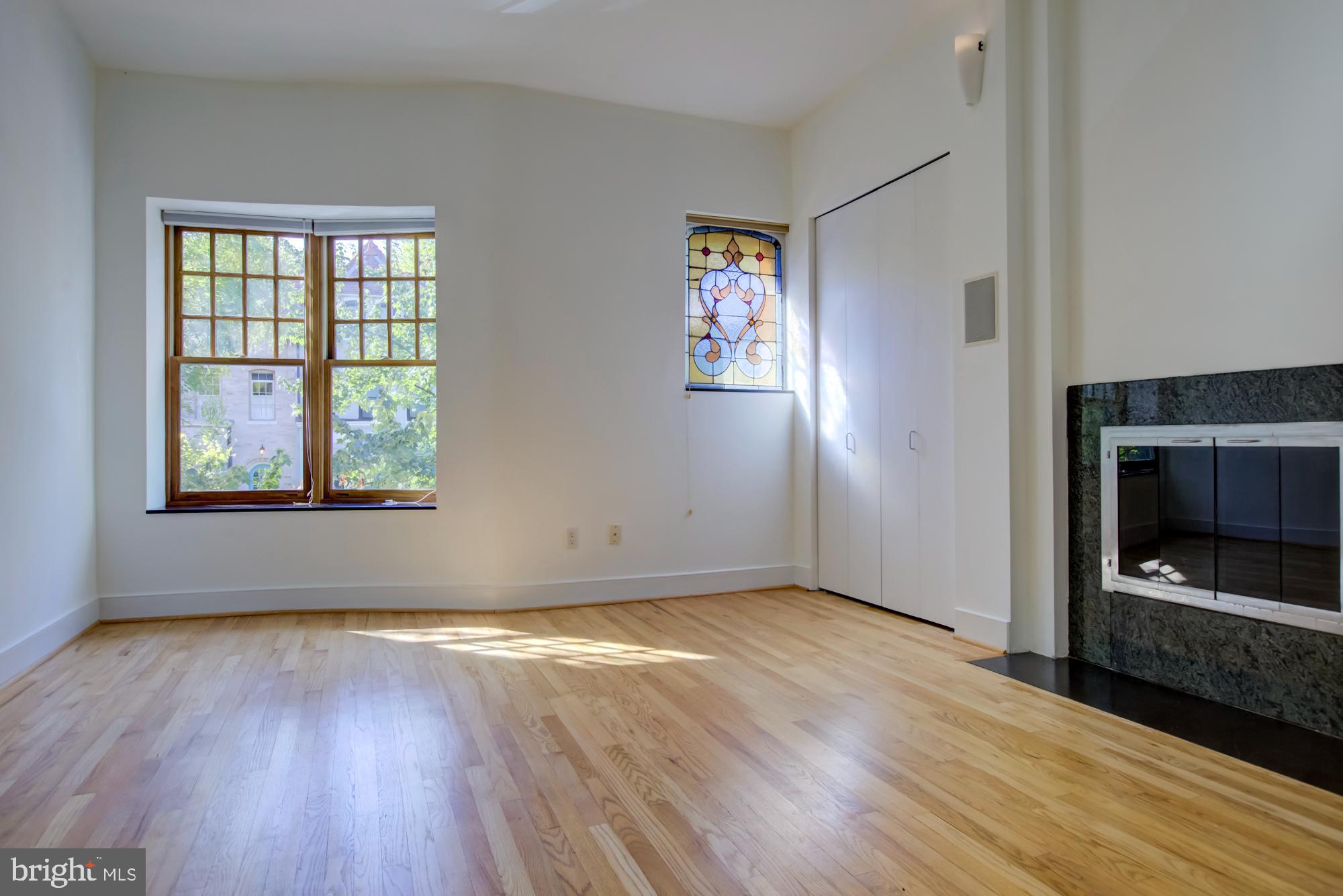 632 C Street Northeast Washington, DC 20002 - Photo 15 of 34 an empty room with wooden floor fireplace and windows