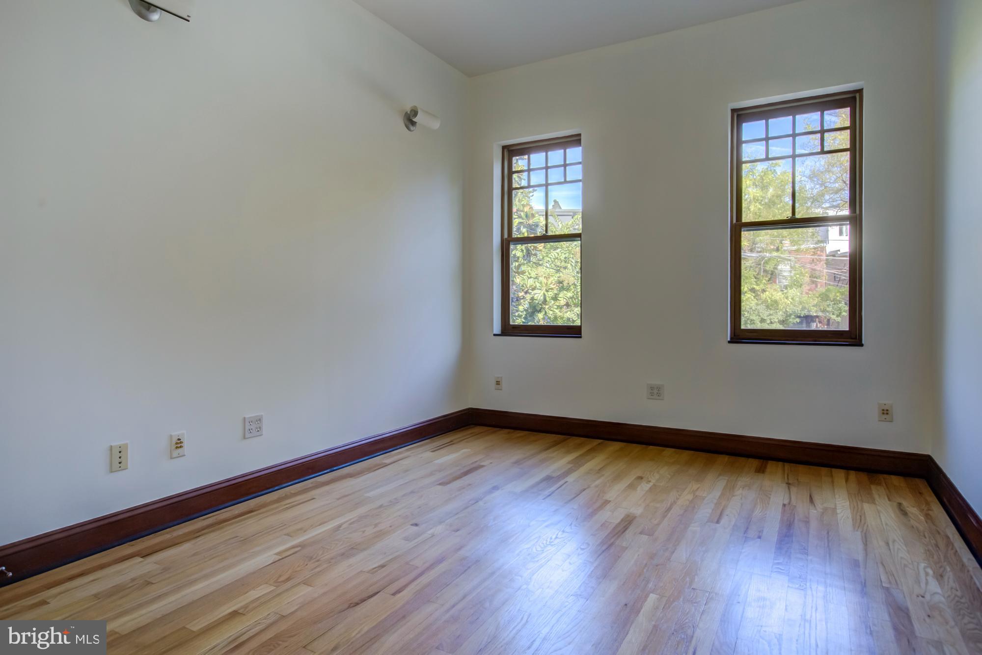 632 C Street Northeast Washington, DC 20002 - Photo 19 of 34 an empty room with wooden floor and windows