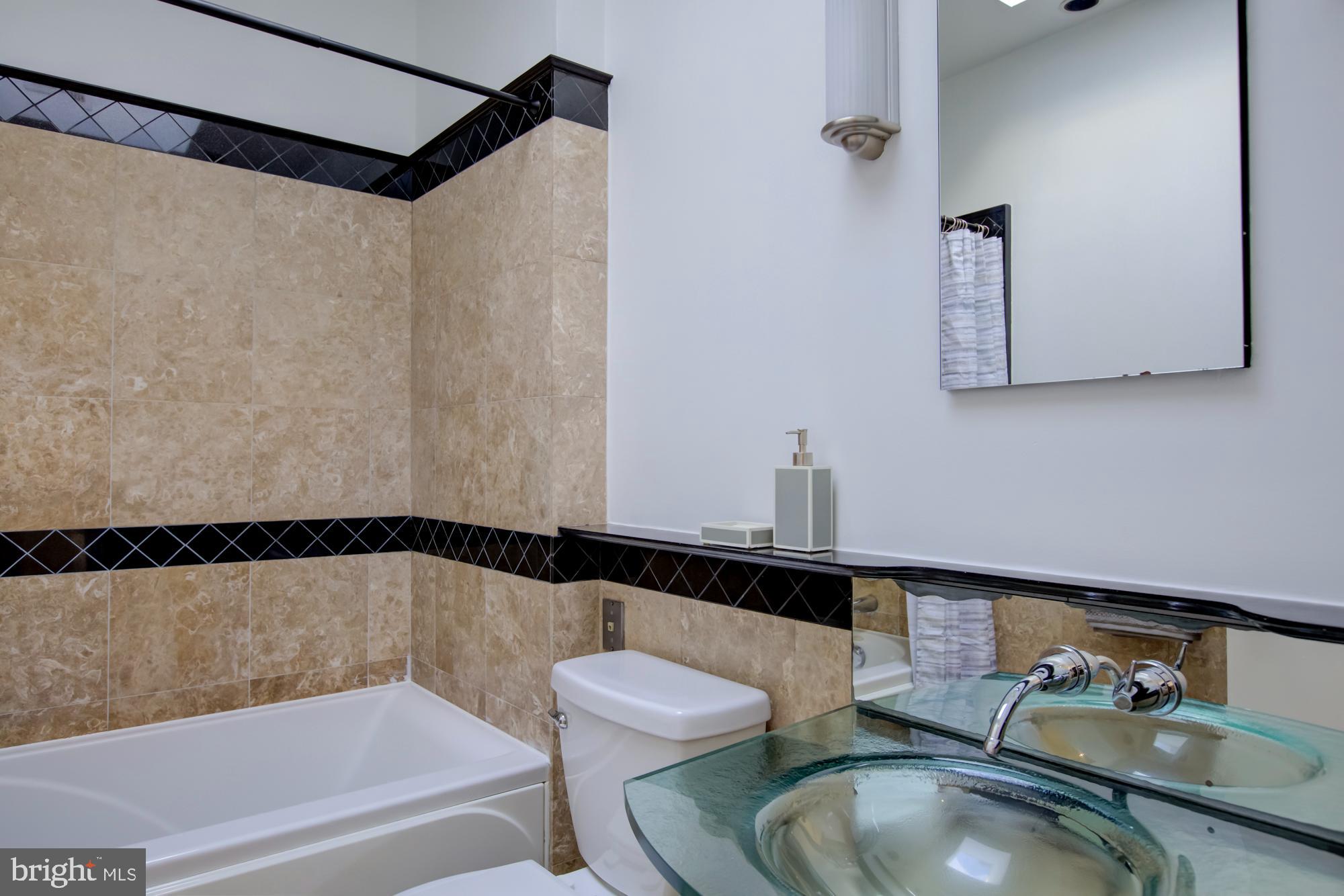 632 C Street Northeast Washington, DC 20002 - Photo 25 of 34 a bathroom with a sink and a mirror