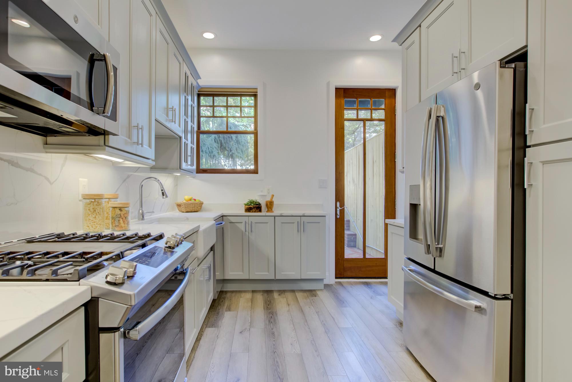 632 C Street Northeast Washington, DC 20002 - Photo 8 of 34 a kitchen with stainless steel appliances granite countertop a refrigerator stove and sink