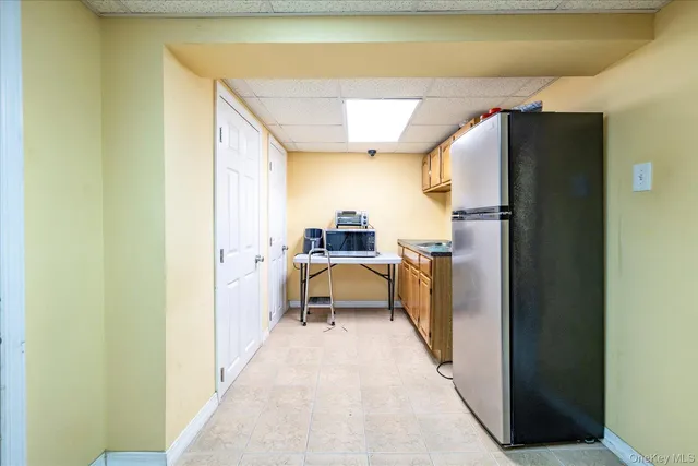 a hallway with a sink and a refrigerator