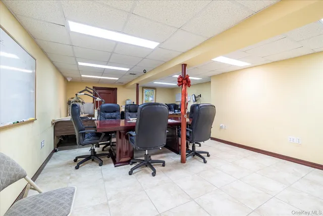 a view of a workspace with furniture and a window
