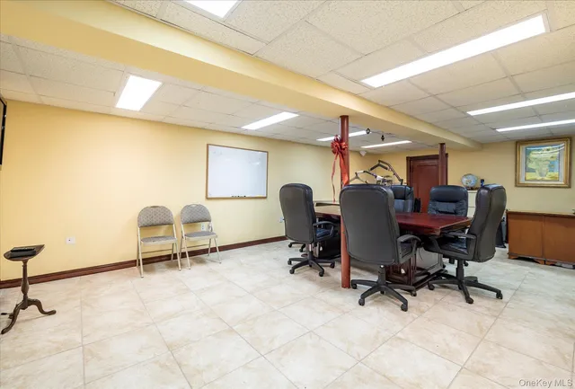 a view of a workspace with furniture and a window