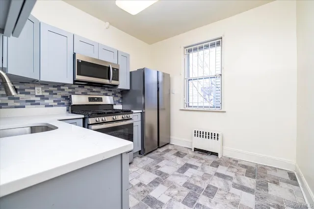 a kitchen with stainless steel appliances a stove microwave and a refrigerator