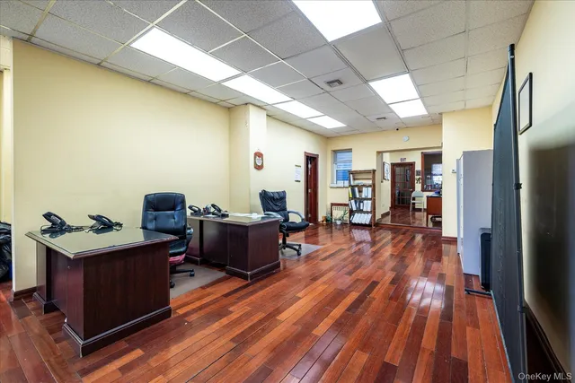 a view of a workspace with furniture and wooden floor