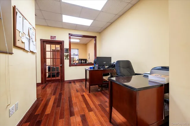 a view of a workspace with furniture and wooden floor
