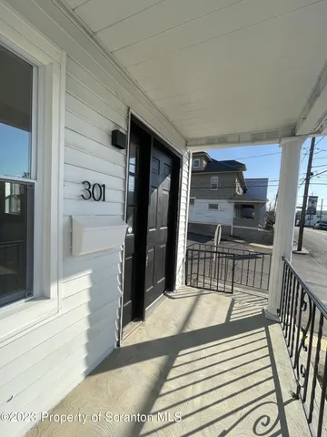 a kitchen with granite countertop a refrigerator and a sink