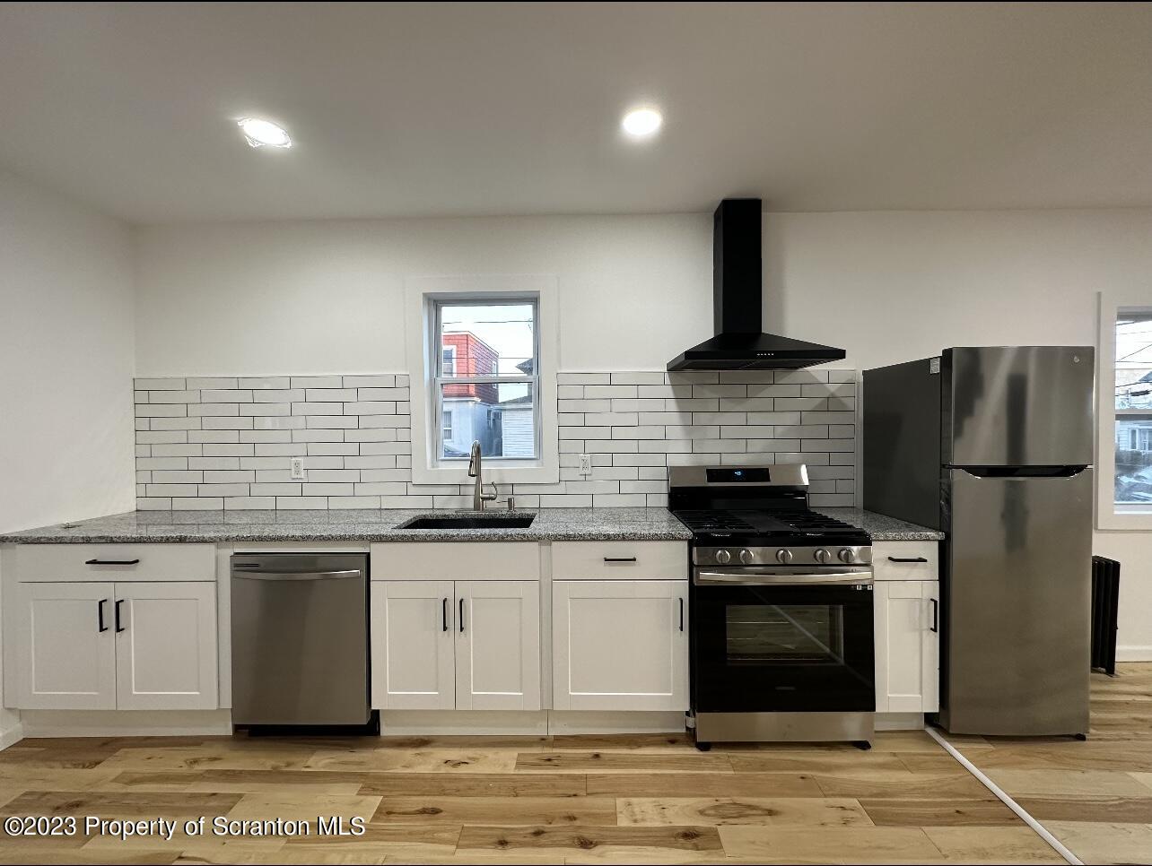 301 Oak Street Old Forge, PA 18518 - Photo 5 of 19 a kitchen with stainless steel appliances granite countertop a stove a sink and a refrigerator