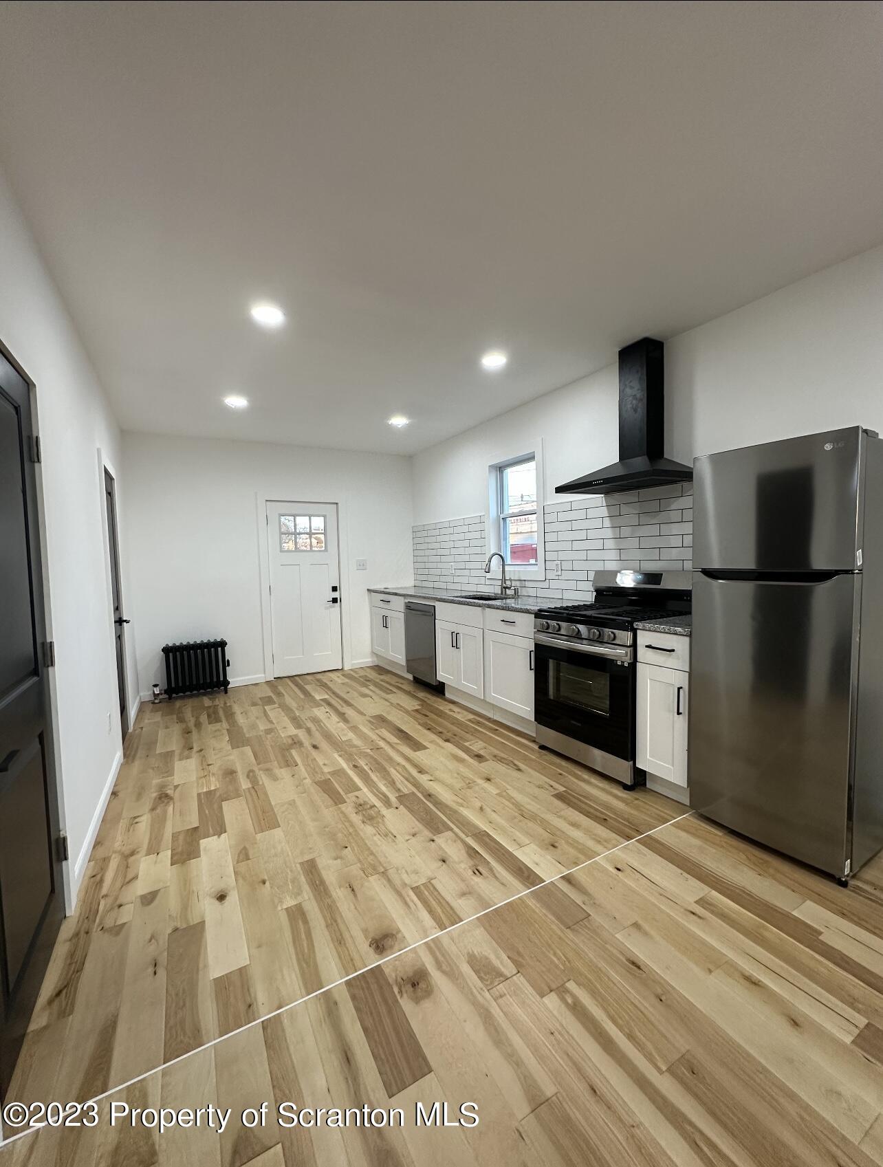 301 Oak Street Old Forge, PA 18518 - Photo 7 of 19 a large kitchen with kitchen island granite countertop a sink and stainless steel appliances