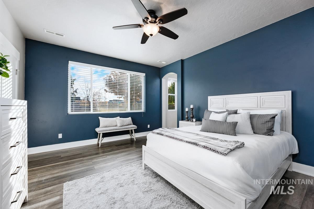3902 North Rotaldo Avenue Meridian, ID 83646 - Photo 15 of 34 Bedroom with a ceiling fan, wood finished floors, and arched walkways