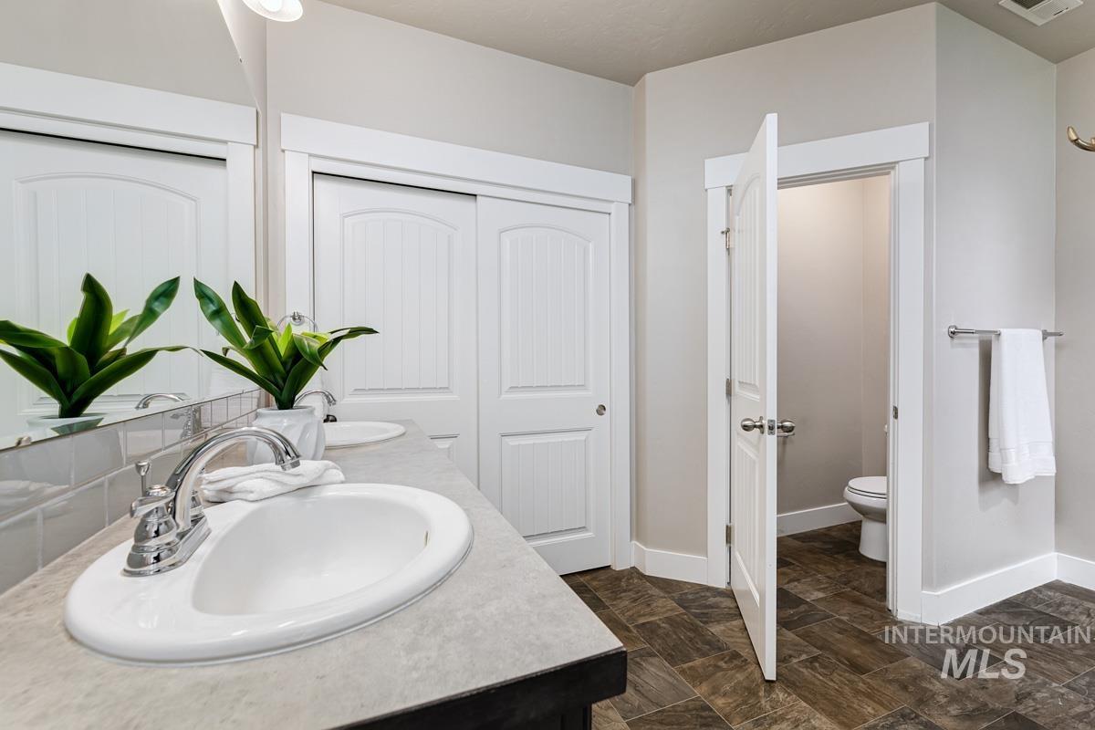 3902 North Rotaldo Avenue Meridian, ID 83646 - Photo 17 of 34 Bathroom featuring toilet and double vanity