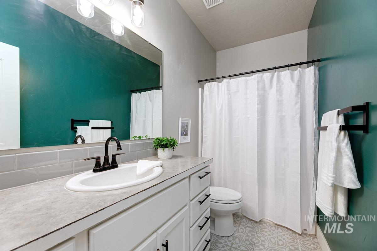 3902 North Rotaldo Avenue Meridian, ID 83646 - Photo 24 of 34 Bathroom with a shower with shower curtain and vanity