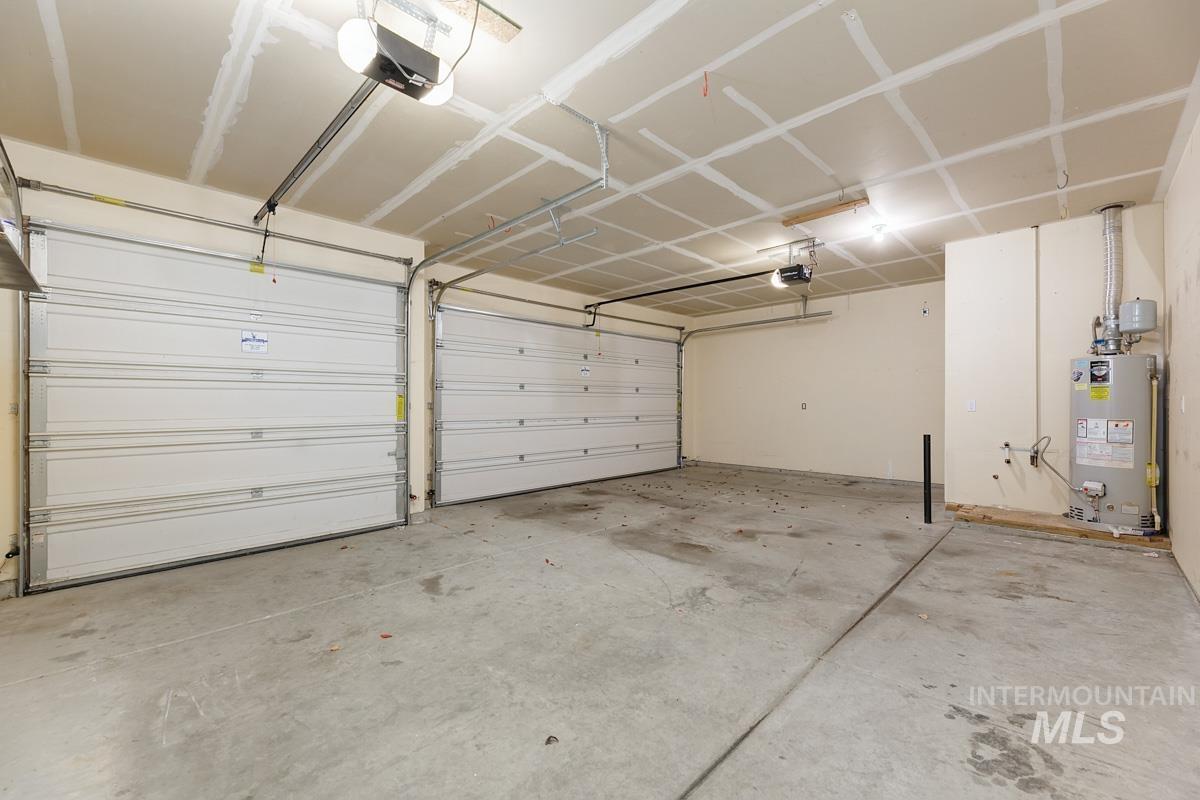 3902 North Rotaldo Avenue Meridian, ID 83646 - Photo 25 of 34 Garage with water heater and a garage door opener