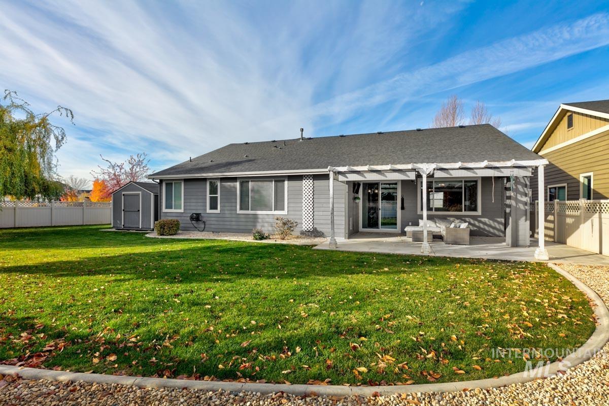 3902 North Rotaldo Avenue Meridian, ID 83646 - Photo 26 of 34 Rear view of property featuring a fenced backyard, a shed, a patio, and a pergola