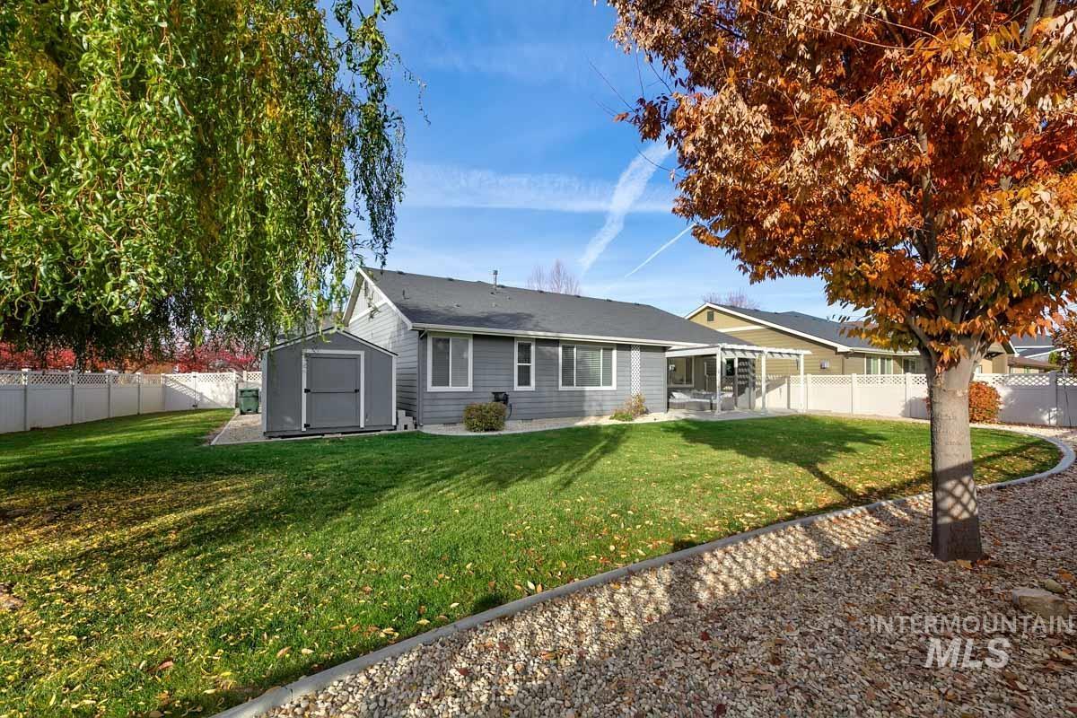 3902 North Rotaldo Avenue Meridian, ID 83646 - Photo 29 of 34 Back of property featuring a fenced backyard, a shed, and a patio