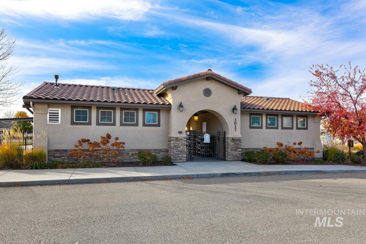 3902 North Rotaldo Avenue Meridian, ID 83646 - Photo 34 of 34 Mediterranean / spanish-style home with stucco siding, a fenced front yard, a gate, and stone siding
