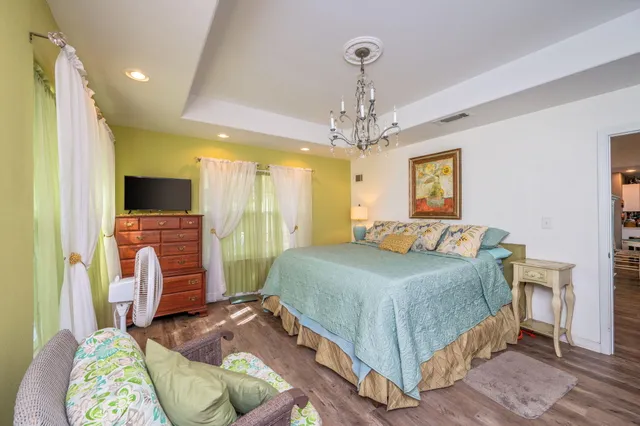 a bedroom with a bed and a flat screen tv