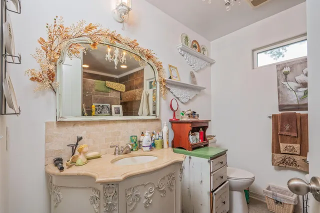 a bathroom with a sink mirror vanity and toilet