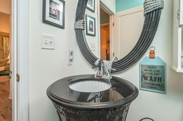 a dining room with wooden floor and a hallway