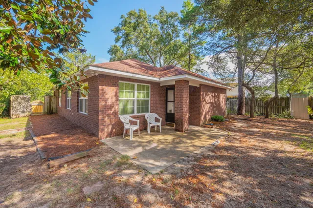a view of a house with backyard porch and sitting area