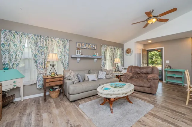 a living room with furniture a rug and a large window