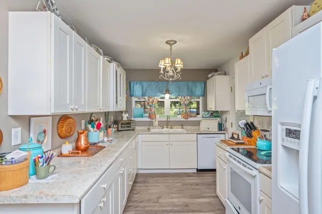 a kitchen with a sink stove and cabinets
