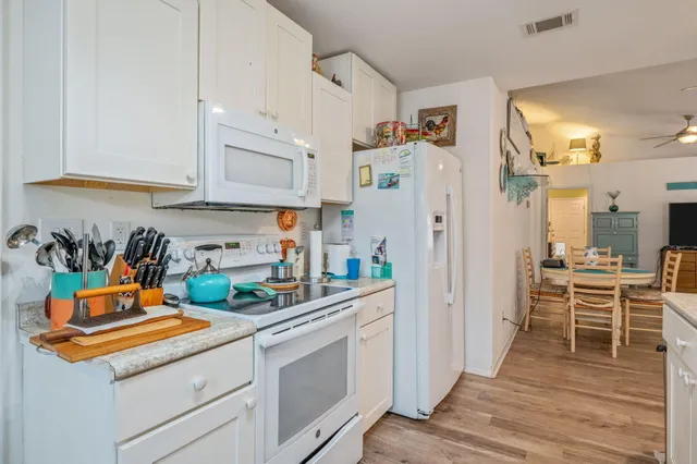 a kitchen with stainless steel appliances granite countertop a refrigerator a stove and a sink