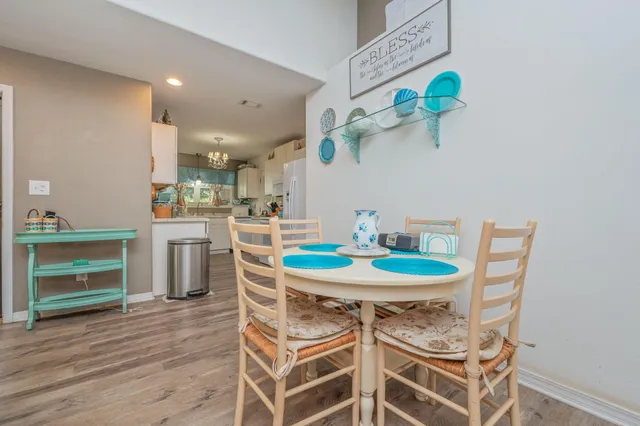 a dining room with furniture and wooden floor