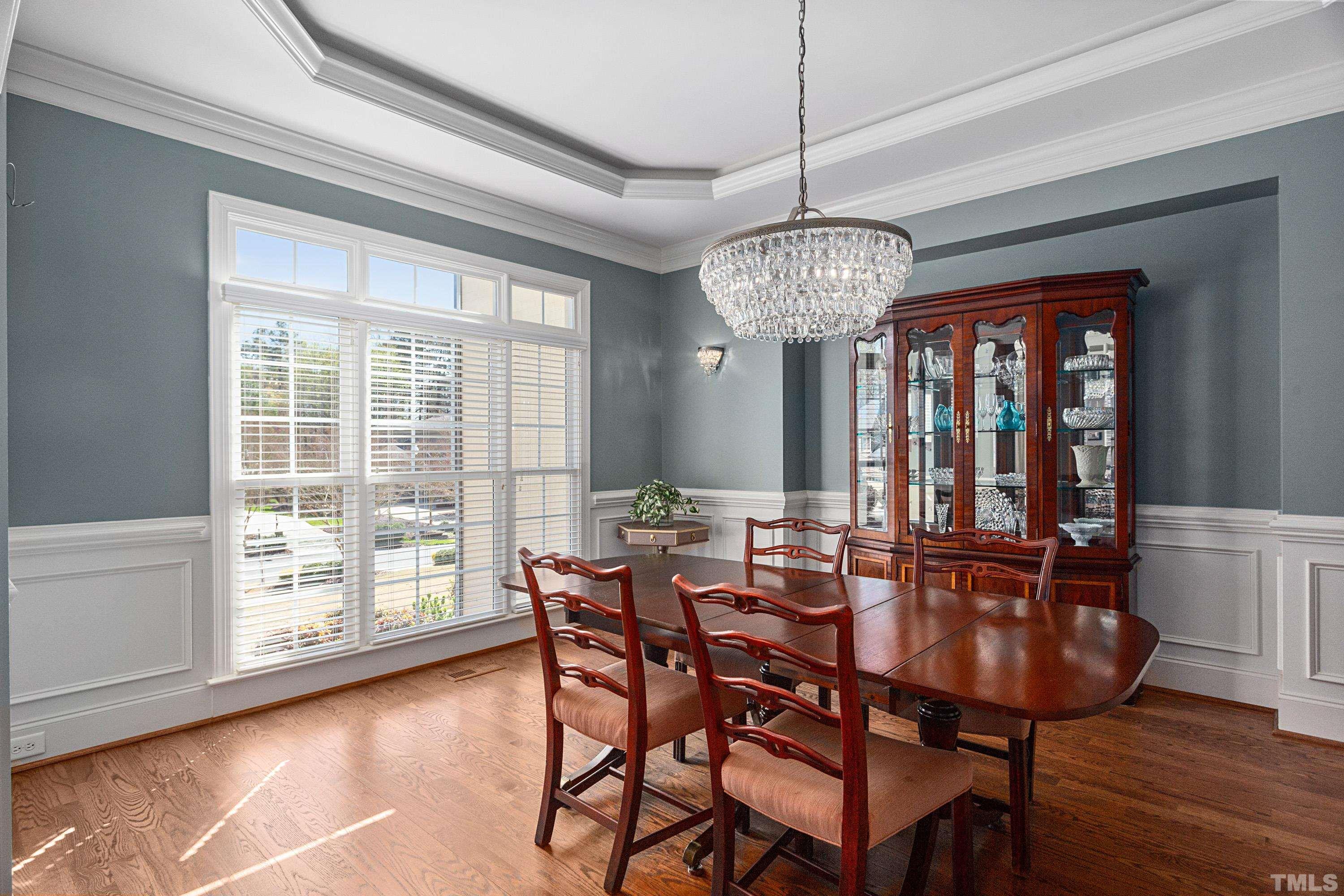 4328 Summer Brook Drive Apex, NC 27539 - Photo 13 of 76 a view of a dining room with furniture wooden floor and chandelier