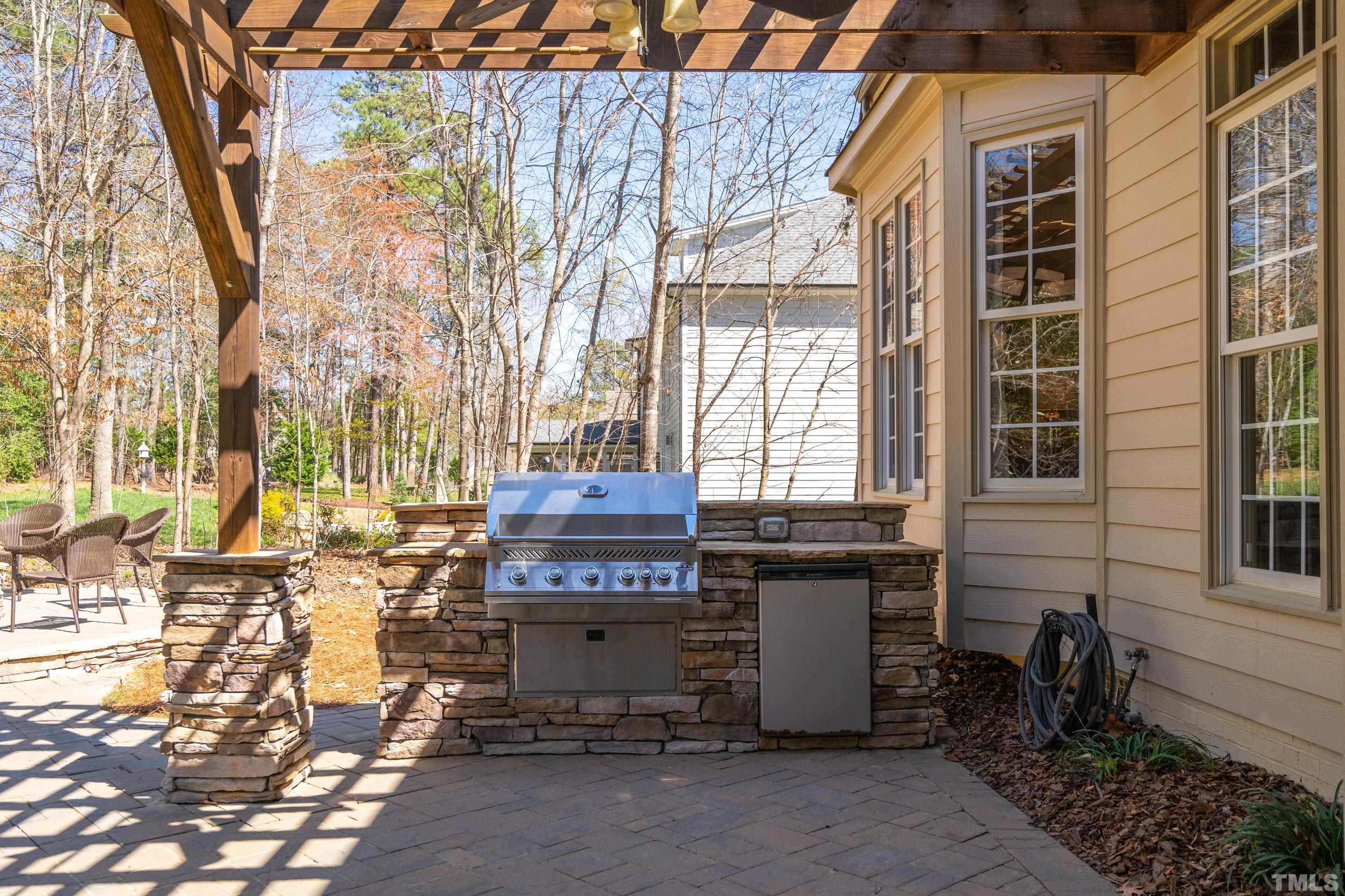 4328 Summer Brook Drive Apex, NC 27539 - Photo 21 of 76 Grill in the shade under the Pergola. Perfect place to set up an outdoor table to dine al fresco.