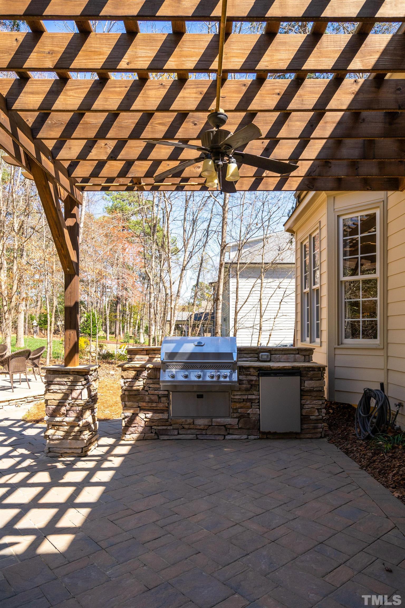 4328 Summer Brook Drive Apex, NC 27539 - Photo 24 of 76 a backyard of a house with barbeque oven table and chairs