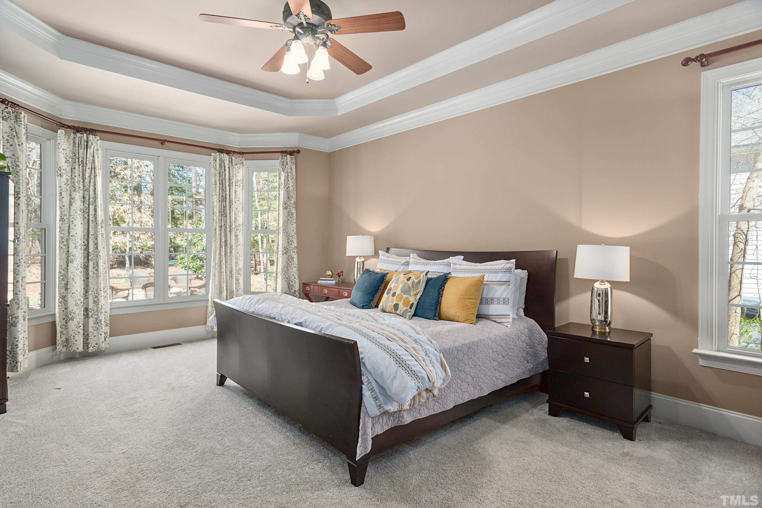 4328 Summer Brook Drive Apex, NC 27539 - Photo 30 of 76 a bed room with a bed and a chandelier