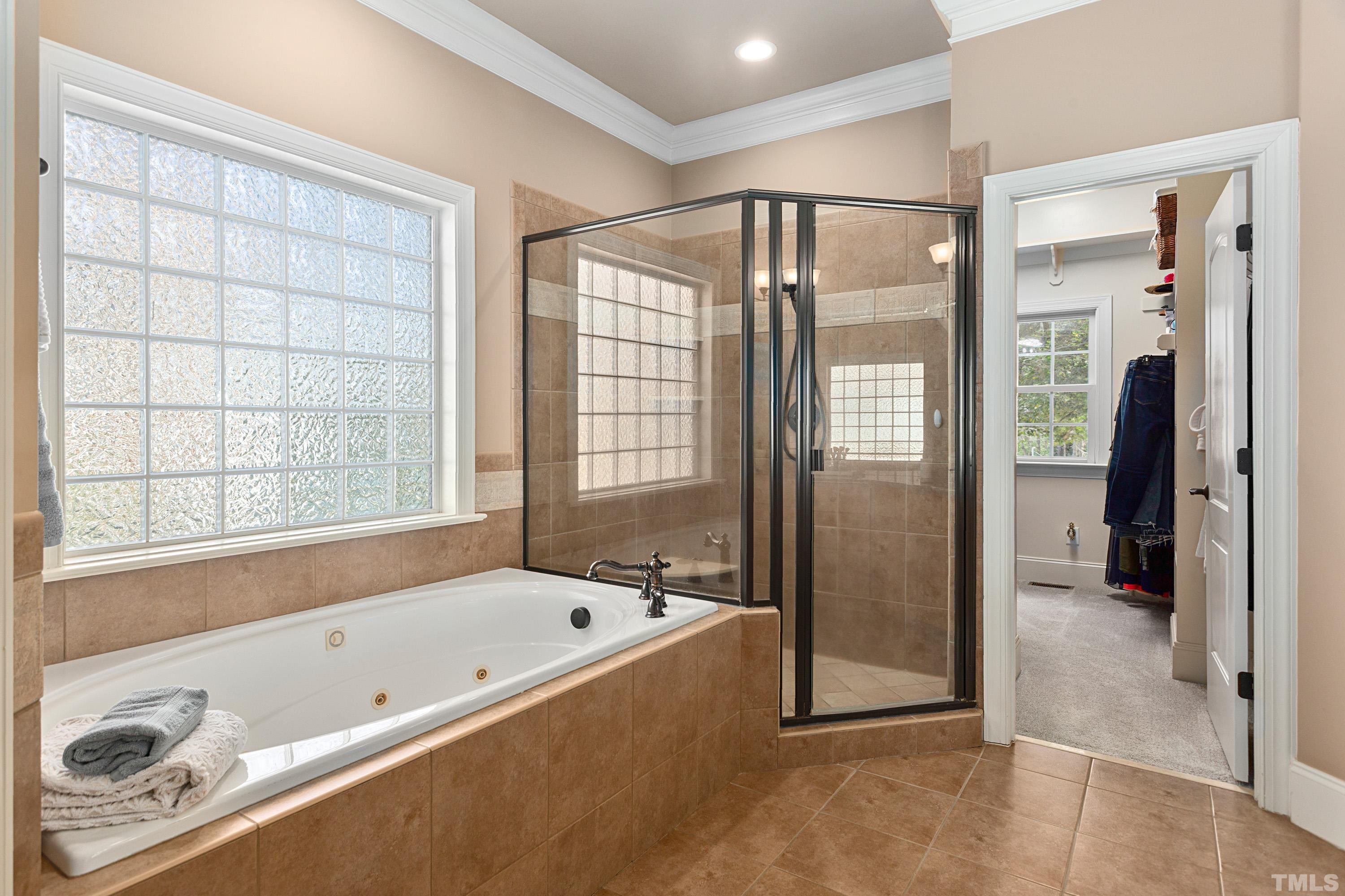 4328 Summer Brook Drive Apex, NC 27539 - Photo 33 of 76 a bathroom with a bathtub and a shower