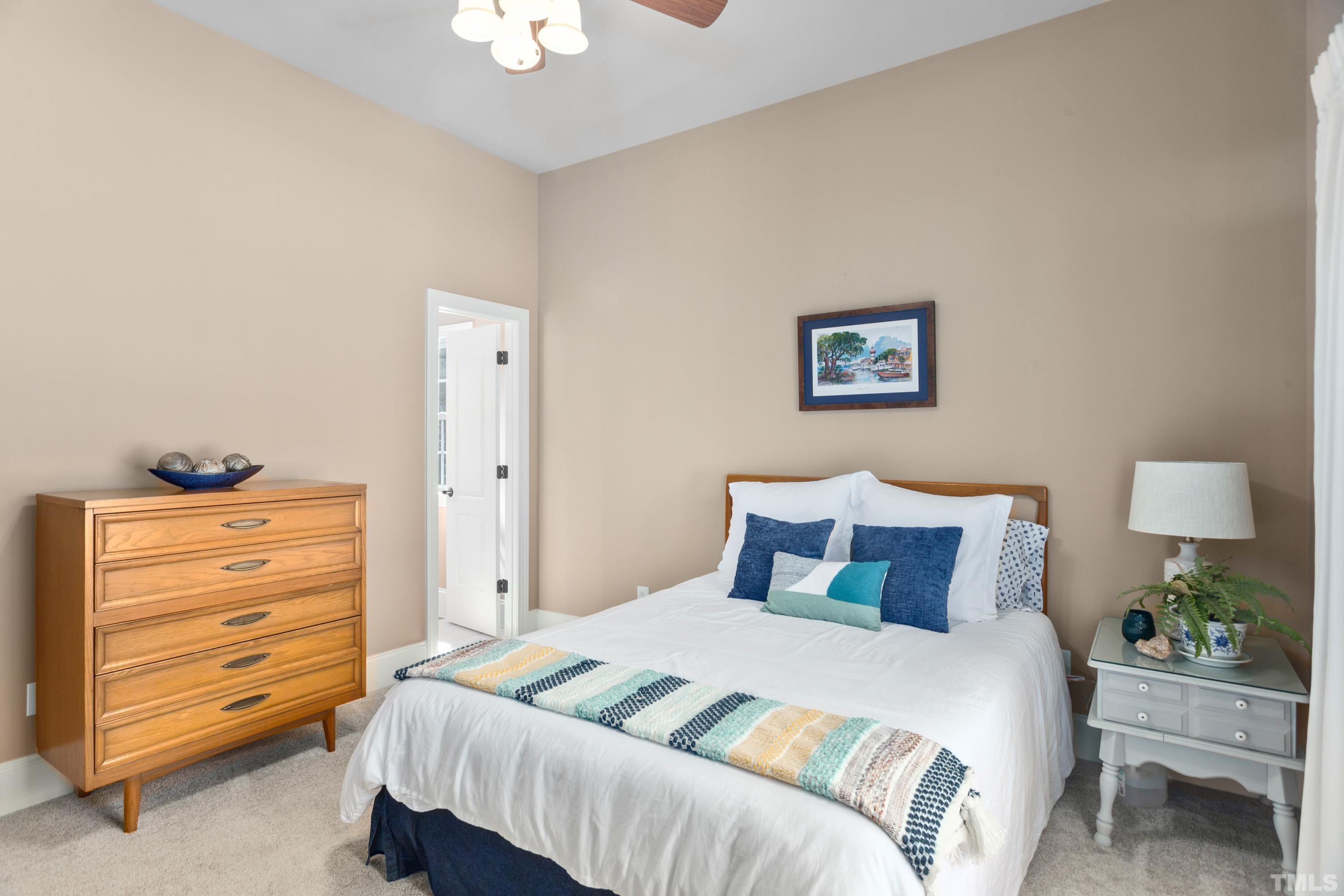 4328 Summer Brook Drive Apex, NC 27539 - Photo 34 of 76 a bedroom with a bed and a dresser