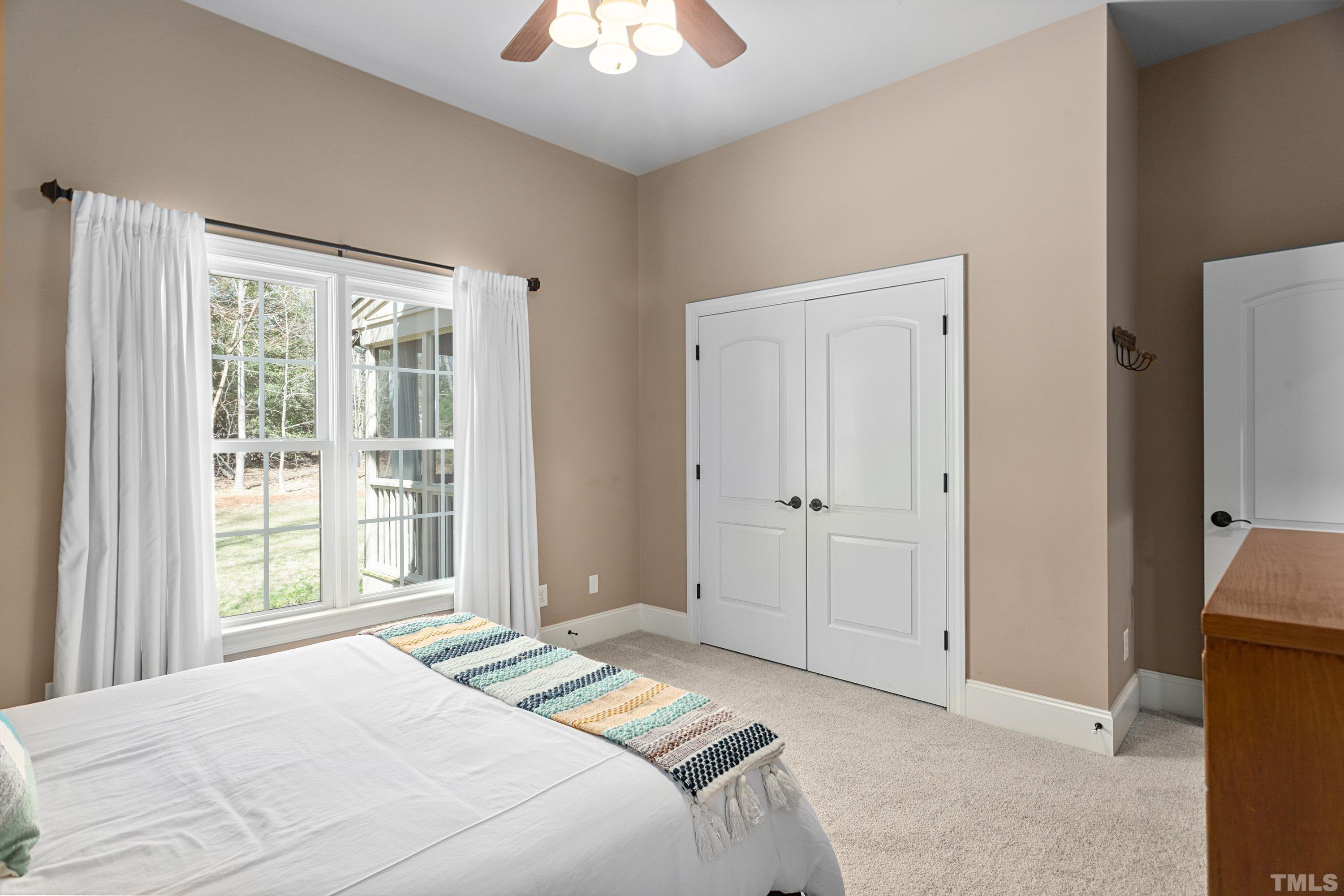4328 Summer Brook Drive Apex, NC 27539 - Photo 35 of 76 a bedroom with a bed and a window