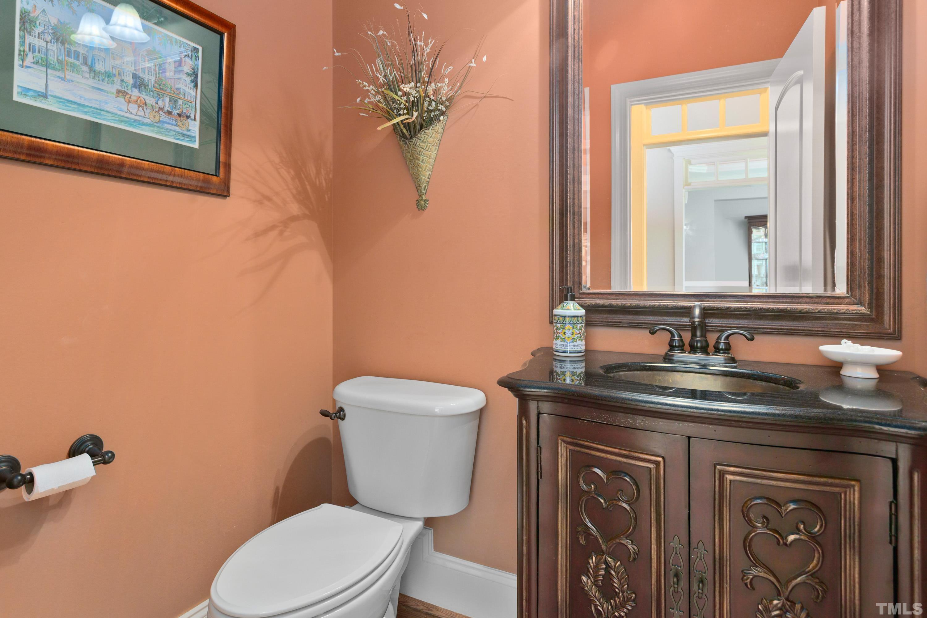 4328 Summer Brook Drive Apex, NC 27539 - Photo 38 of 76 a bathroom with a granite countertop toilet sink and mirror