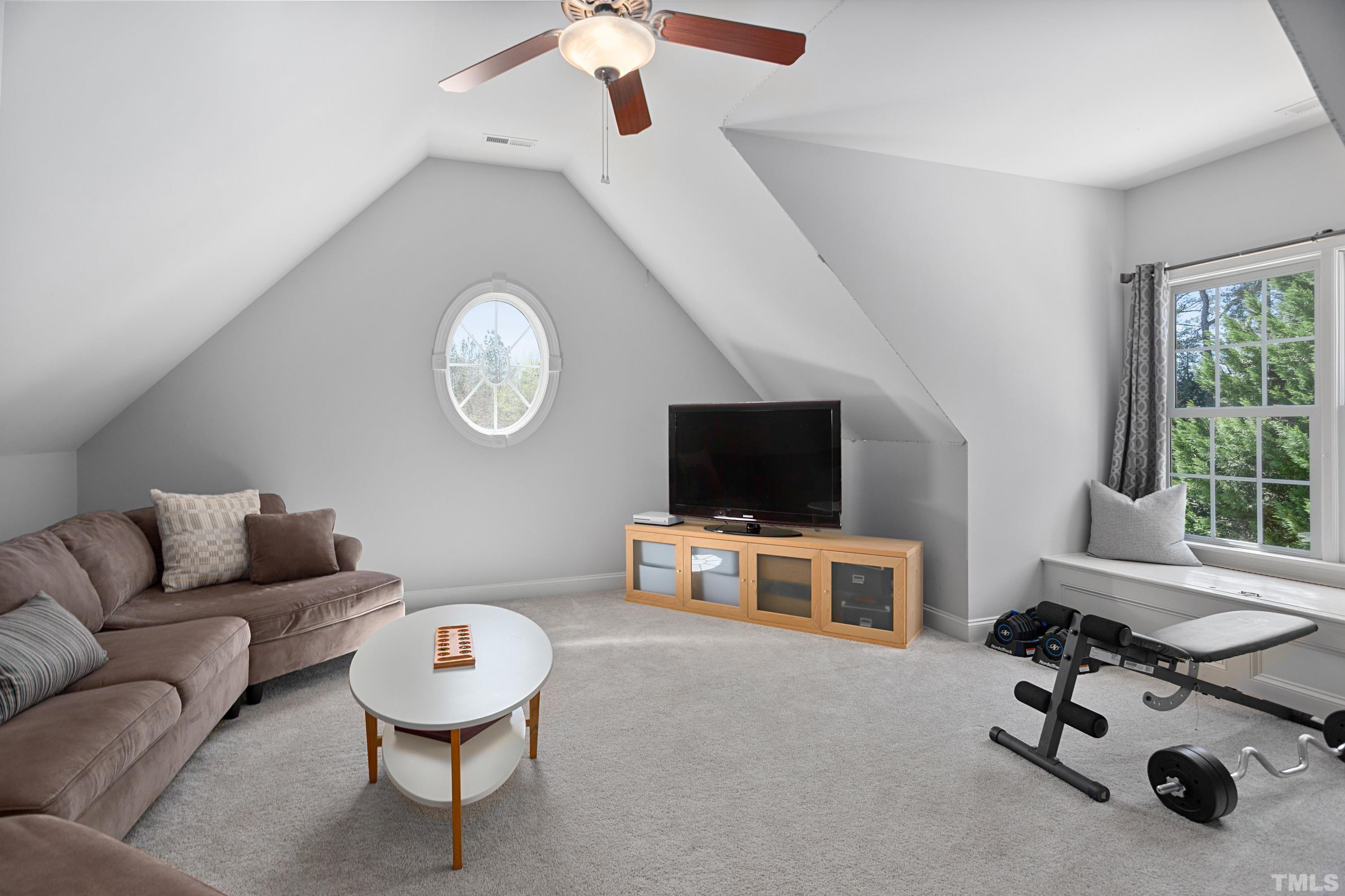 4328 Summer Brook Drive Apex, NC 27539 - Photo 39 of 76 a living room with furniture and a flat screen tv